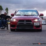 A passenger gets ready for a go around the track during the Driving to Excel experience at the Bob Bondurant High Performance Driving School in Chandler, Ariz.