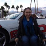Christina Chambers poses in front of "her" Camaro during the Driving to Excel event at the Bob Bondurant School of High Performance Driving in Chandler, Ariz.