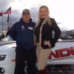 Pat Bondurant (right) poses with a participant during the Driving to Excel event at the Bob Bondurant School of High Performance Driving in Chandler, Ariz.