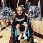 Aaliyah in her cheer uniform cheering on our local college basketball team