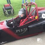 Eric Rine leaves his chair behind to get behind the wheel of this mini race car.