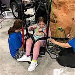Izabella Uccello gives the rock wall a go at the Abilities Expo