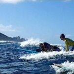 Michael (center) rides the waves of Hawaii