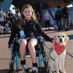 Siena and her service dog, Lustra enjoy the happiest place on earth.