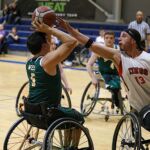 Kings player David Gonzales, Jr.,13, reaches for a block against Nick Weiss, #5, during a game at the 21st Annual D1 Wheelchair Basketball Tournament in Phoenix, Ariz. (Photo by Christopher Di Virgilio).
