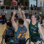 The jazz's Josh Poulson, #14, gets the block at the 21st Annual D1 Wheelchair Basketball Tournament in Phoenix, Ariz. (Photo by Christopher Di Virgilio).