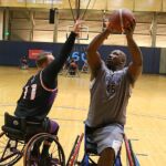 Anthony Pone, #45, makes a shot against Sun's Robert Reed, #11, at the 21st Annual D1 Wheelchair Basketball Tournament in Phoenix, Ariz. (Photo by Christopher Di Virgilio).
