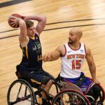 Joshua Poulson, No. 14, makes a pass against David Eng, No. 15, at the 2020 Toyota national Wheelchair Basketball Tournament in Wichita, Kan. (Photo by Christopher Di Virgilio).
