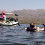 An adaptive water skier and rescue swimmer wait as the tow boat untangles the line during the 2020 Arizona Adaptive Water Sports Day on the Lake in Carefree, Ariz. (Photo by Christopher Di Virgilio). tow_boat01