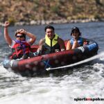 Jo Crawford (right), Andrew Bogdanov (center) and Sharon Hemerka enjoy tubing at Bartlett Lake in Carefree, Ariz., during the 2020 Arizona Adaptive Watersports Day on the Lake. (Photo by Christopher Di Virgilio). sns_tubing01