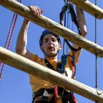 Ryan Helgerson navigates the rock wall at the climbing challenge course at the National Ability Center in Park City, Utah during the 2021 Submerged Festival. (Photo by Christopher Di Virgilio).