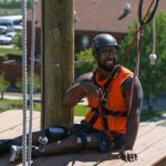 Aaron Murray takes a break before moving onto another obstacle at the climbing challenge course at the National Ability Center in Park City, Utah during the 2021 Submerged Festival. (Photo by Christopher Di Virgilio).