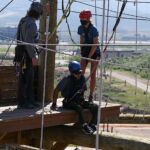Josue Acaron gets ready to cross a section at the climbing challenge course at the National Ability Center in Park City, Utah during the 2021 Submerged Festival. (Photo by Christopher Di Virgilio).