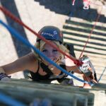Skylar Zamalloa makes her way up the pirates ladder at the climbing challenge course at the National Ability Center in Park City, Utah during the 2021 Submerged Festival. (Photo by Christopher Di Virgilio).