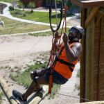 Aaron Murray crosses a section of the climbing challenge course at the National Ability Center in Park City, Utah during the 2021 Submerged Festival. (Photo by Christopher Di Virgilio).
