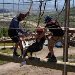 Amber Rangel is assisted across works the climbing challenge course at the National Ability Center in Park City, Utah during the 2021 Submerged Festival. (Photo by Christopher Di Virgilio).