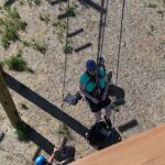 Karen Lorh works her way to the top of the climbing challenge course at the National Ability Center in Park City, Utah during the 2021 Submerged Festival. (Photo by Christopher Di Virgilio).