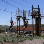 Kiland Sampa (left) and Ryan Helgerson enjoy the climbing challenge course at the National Ability Center in Park City, Utah during the 2021 Submerged Festival. (Photo by Christopher Di Virgilio).