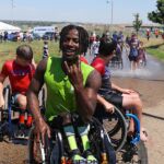 This year's SPORTS 'N SPOKES Junior Athlete of the Year winner, Delmace Mayo, is all smiles after a refreshing few runs through the water spray provided by the Westminster Fire Department. (Photo by Christopher Di Virgilio).
