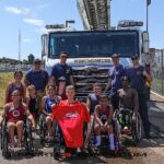 Junior athletes gather with members of the Westminster Fire Department who came out to offer a refreshing break from competition. (Photo by Christopher Di Virgilio).