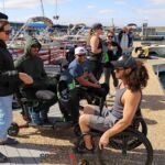 Adaptive wake surfers and supporters chat at the Wild West Wake Surf Shootout 2024. (Photo by Brittany Martin).