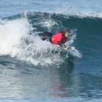 Jocelyn Neumueller competing in the prone-assist division during the 2024 Stoke For Life U.S. Open Adaptive Surfing Championships in Oceanside, Calif. (Photo by Rich Jayne/Awaze Media).
