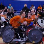 Members of the Texas Stampede surround James Adams, No. 5, during the 2025 USWRA Championships. (Photo by Christopher Di Virgilio).