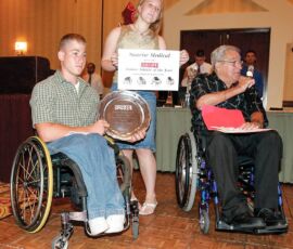 National Junior Disabled Sports Championships, July 11-17, 2004,Mesa, AZ
Michael Timpa, left, receives the SNS Junior Athlete of the Year award from editor -in-chief Cliff Crase and Tori Crase during the Games banquet. (Photo by Nancy Crase). Michael Timpa