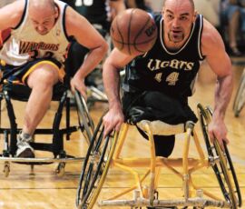 NWBT Division II Final, April 9, 2005 -Alberta Northern Lights Trooper Johnson brings the ball down court followed closely by a Golden State Warrior Peter Sanchez during the championship game in Division II. (Photo by Nancy Crase). Trooper Johnson